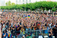 Audience at Pride Festival holding flags