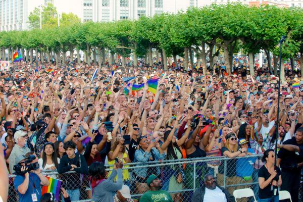 Audience at Pride Festival holding flags