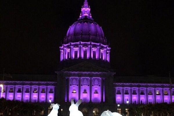 Plaza illuminated purple at night