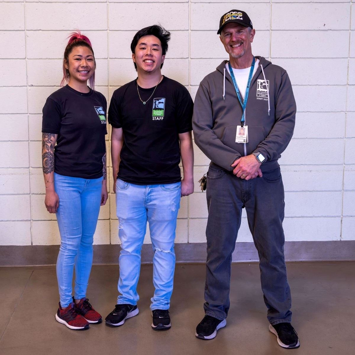 jessica huey, jonathan lee, lucas tobin standing in front of a white brick wall