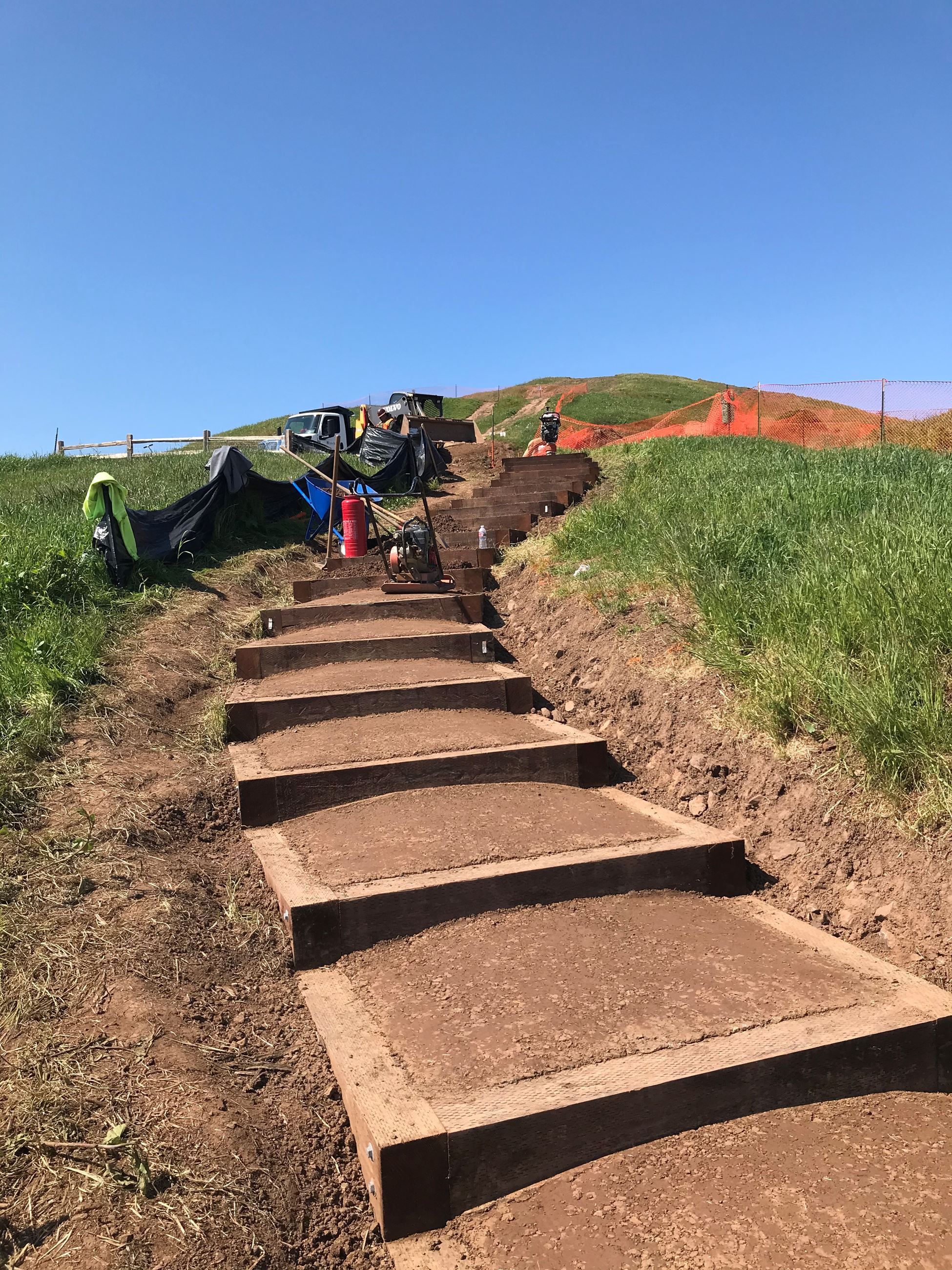View of Box Steps Up Bernal Hill (Foreground) and construction crew next to orange construction fenc