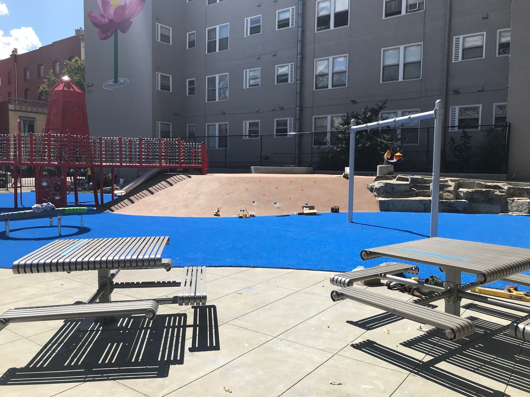Seen here are two picnic tables, one with three bench seats and one with four bench seats on top of 