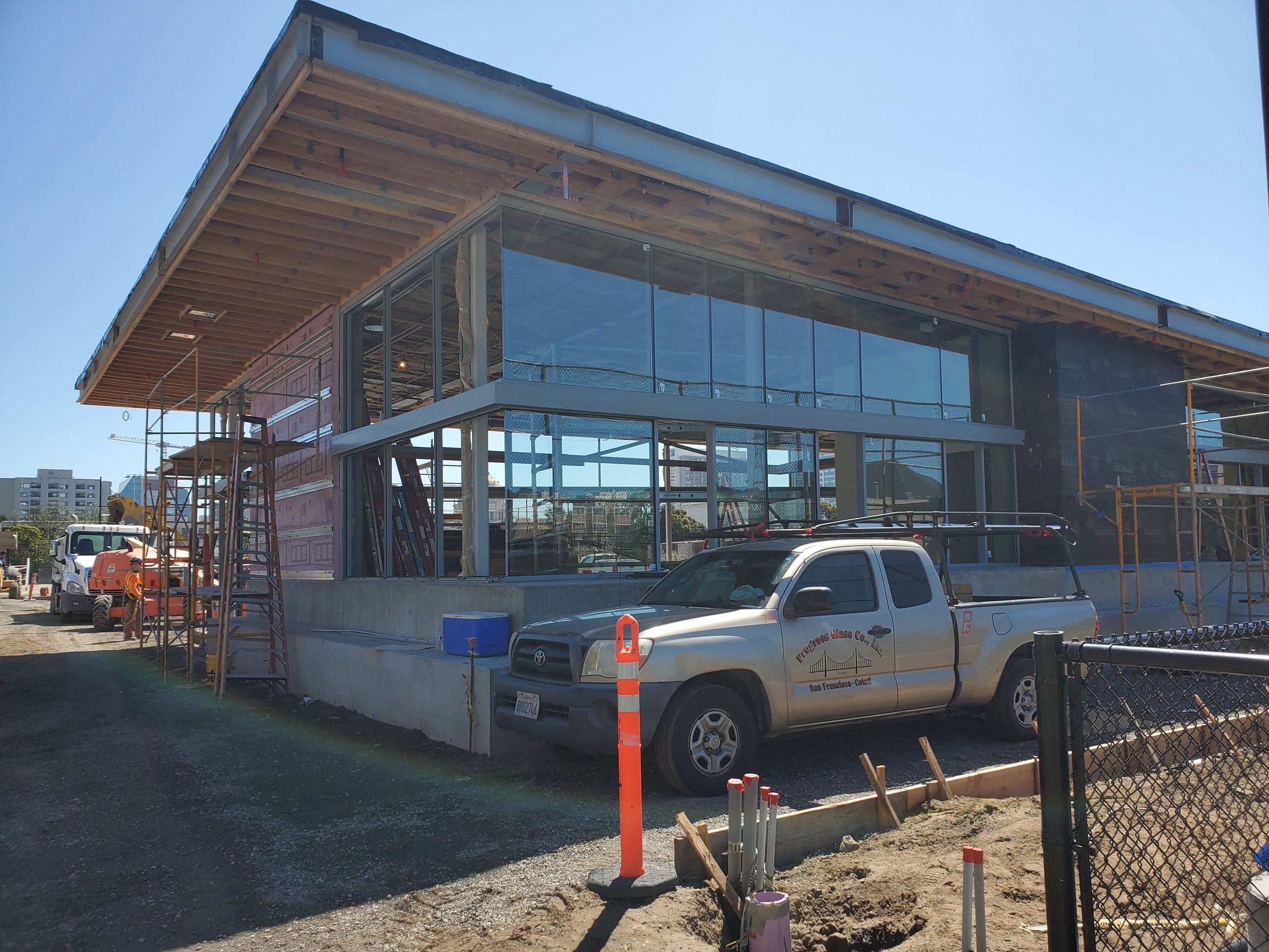 Photo is showing the clubhouse under construction, tall windows with a slanted roof