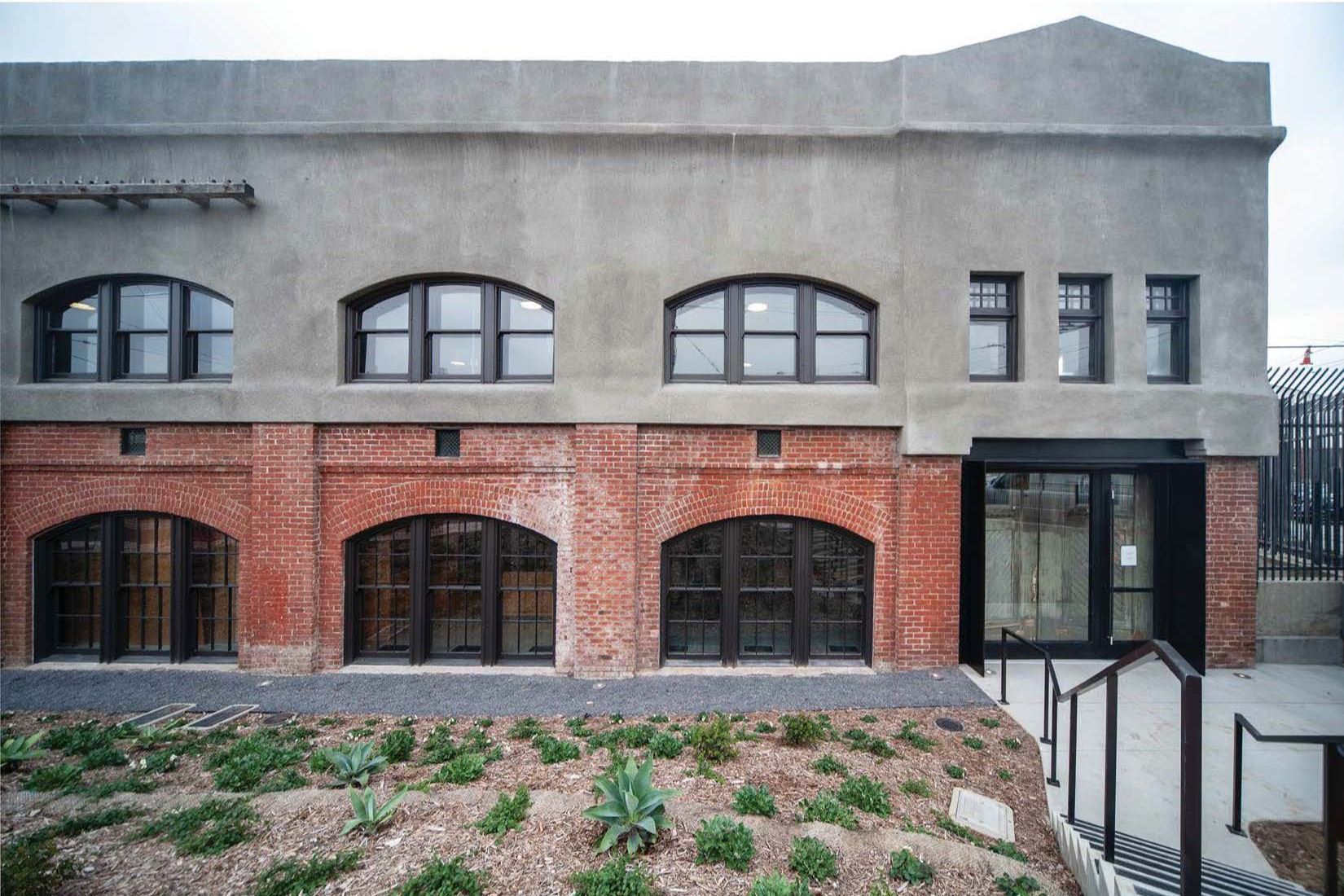 Photo is showing the Front elevation south entrance view of the exterior of the building with brick 