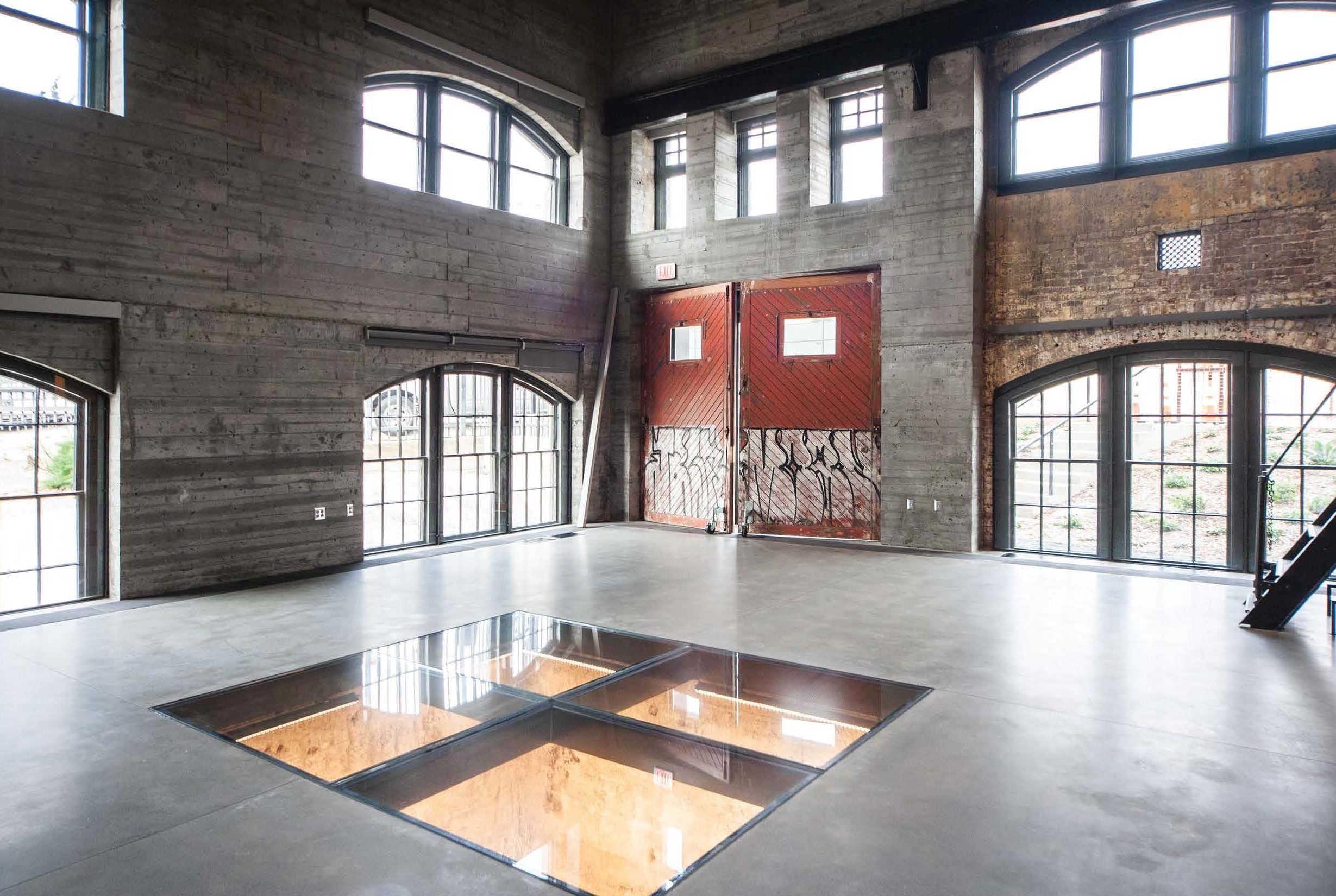 Geneva Car Barn Interior South West corner and south exit with glass doors outlined in black steel. 