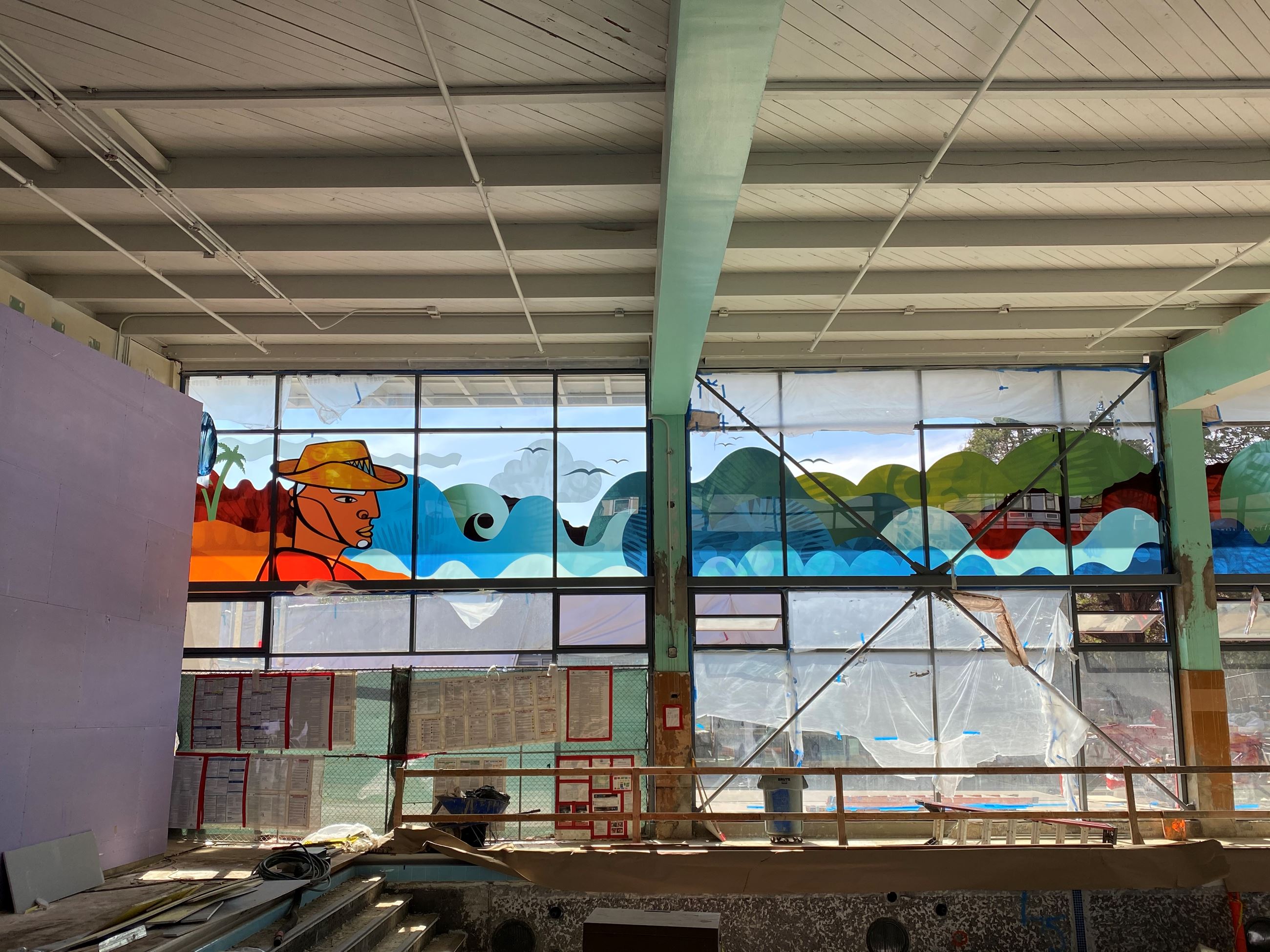 Image is taken from the inside of the Garfiled pool building showing newly installed windows with a 