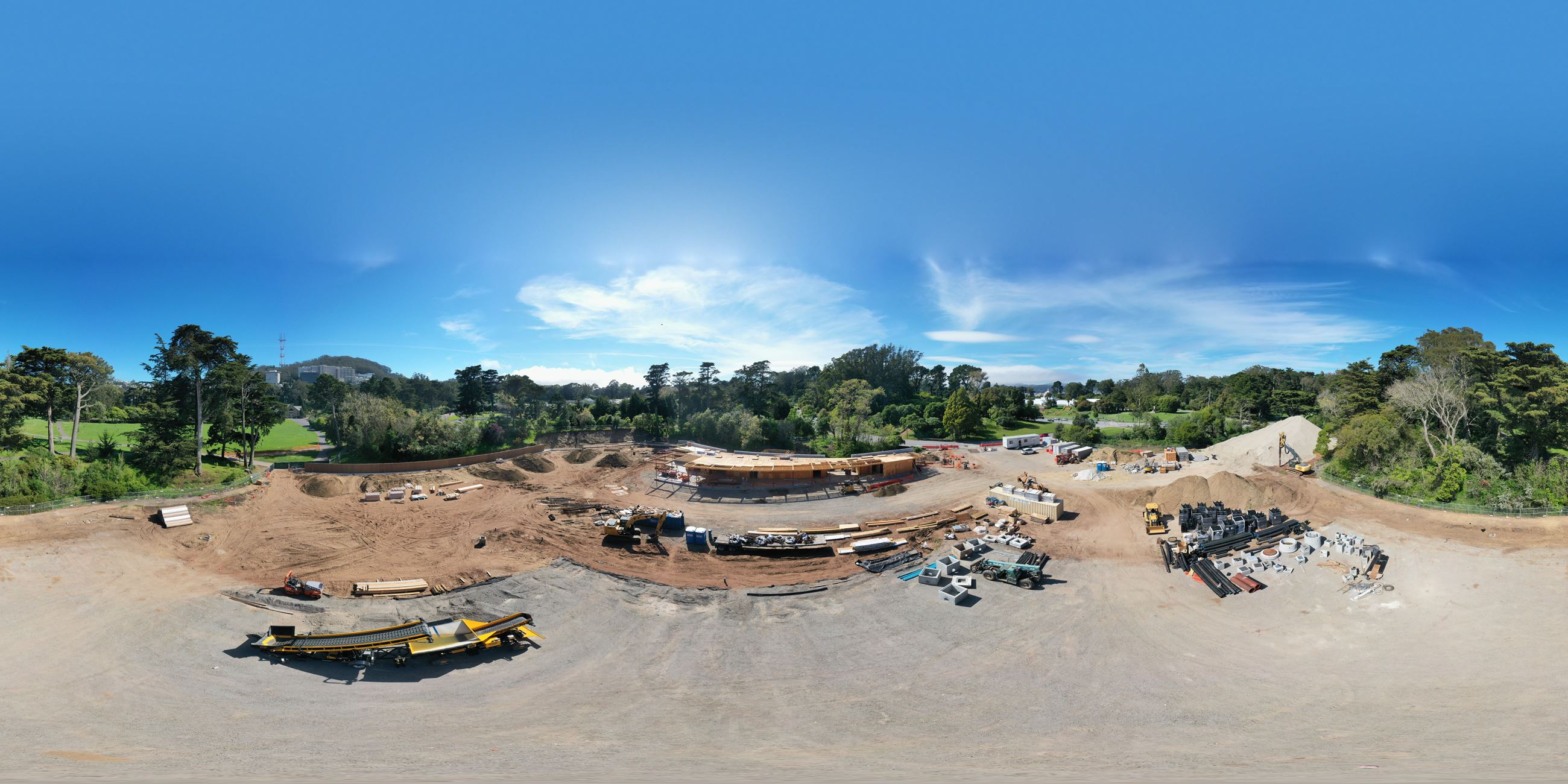 Image is from a drone shot above the Tennis Center courts which are demolished. The image shows cons