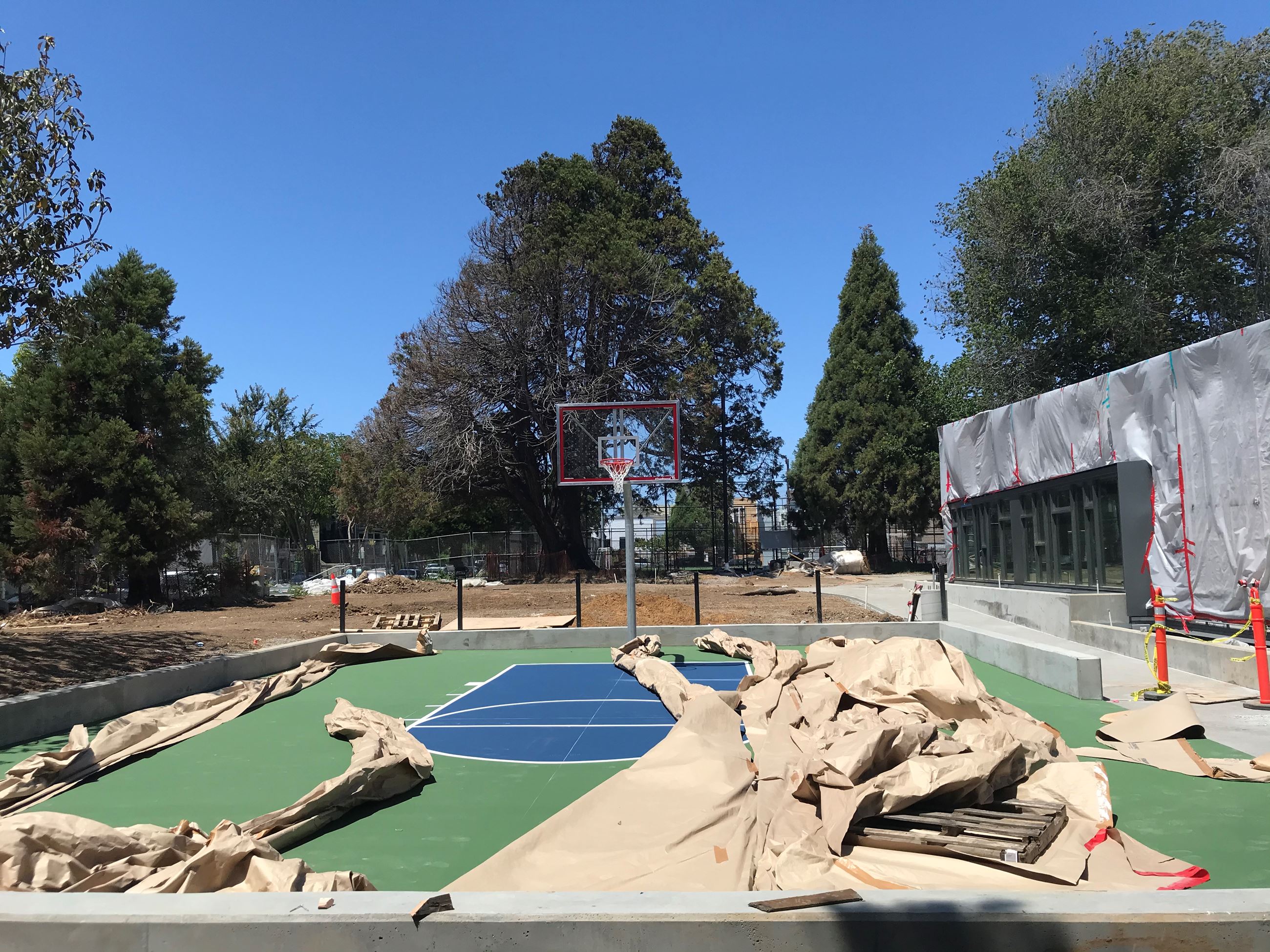 The photo shows a half basketball court in the middle, partially covered in brown construction paper