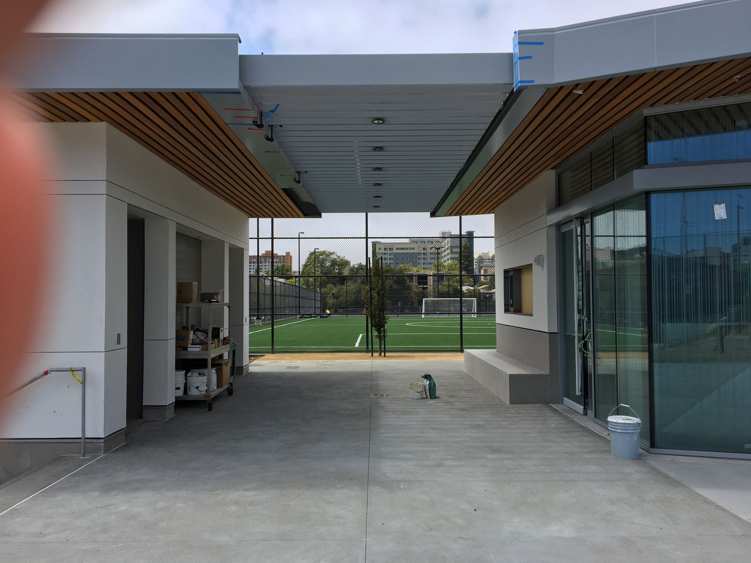 Foyer of the clubhouse with glass wall entrance on the right, covered in between restroom area,