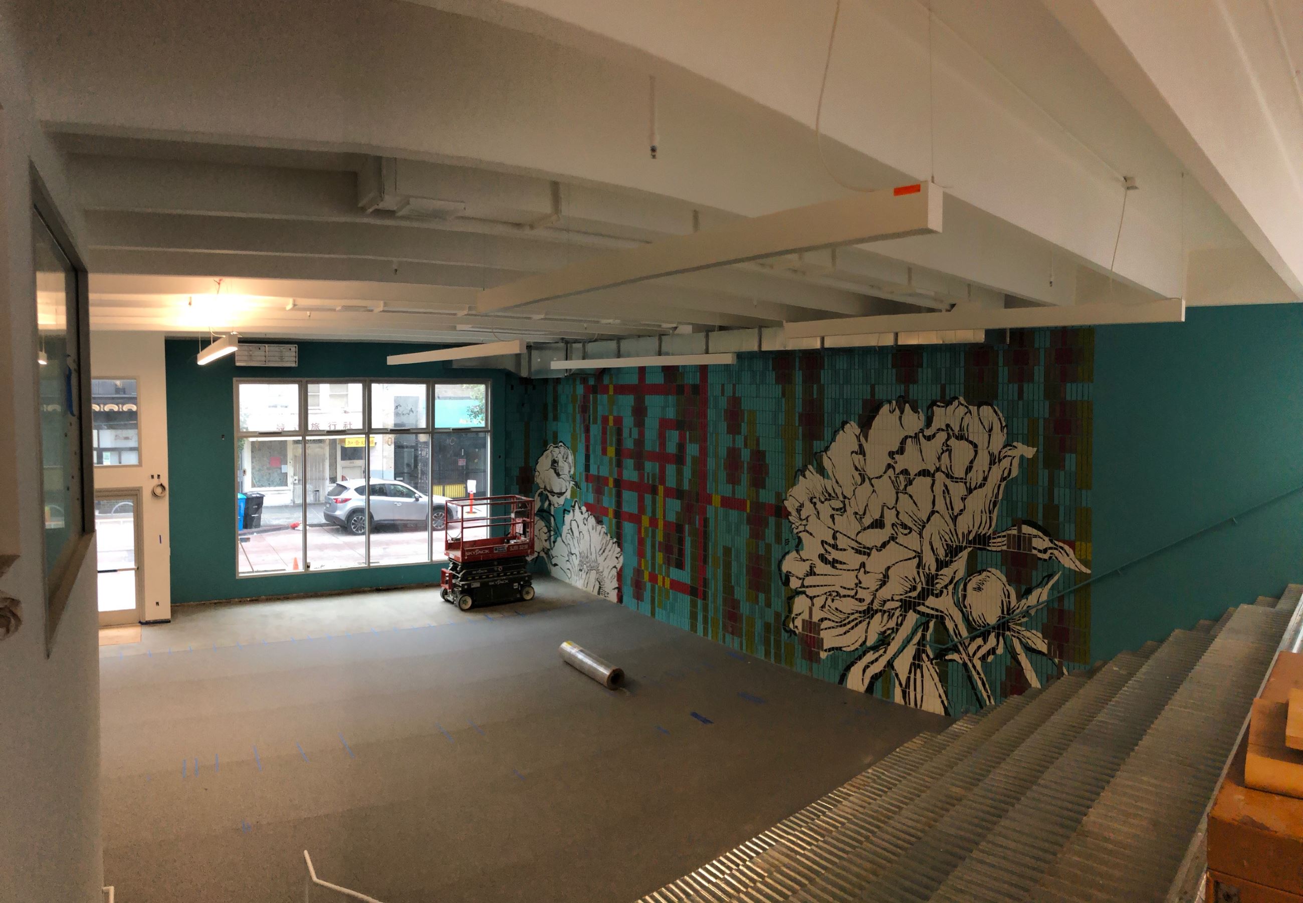 Inside the clubhouse, view towards the outside with a colorful mural on the right side