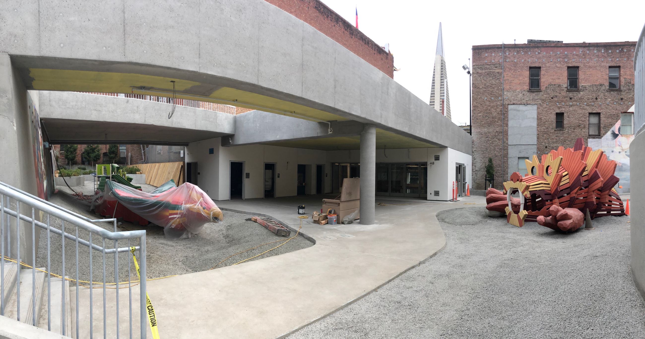 Inside the playground facing the clubhouse showing two red dragon play equipment