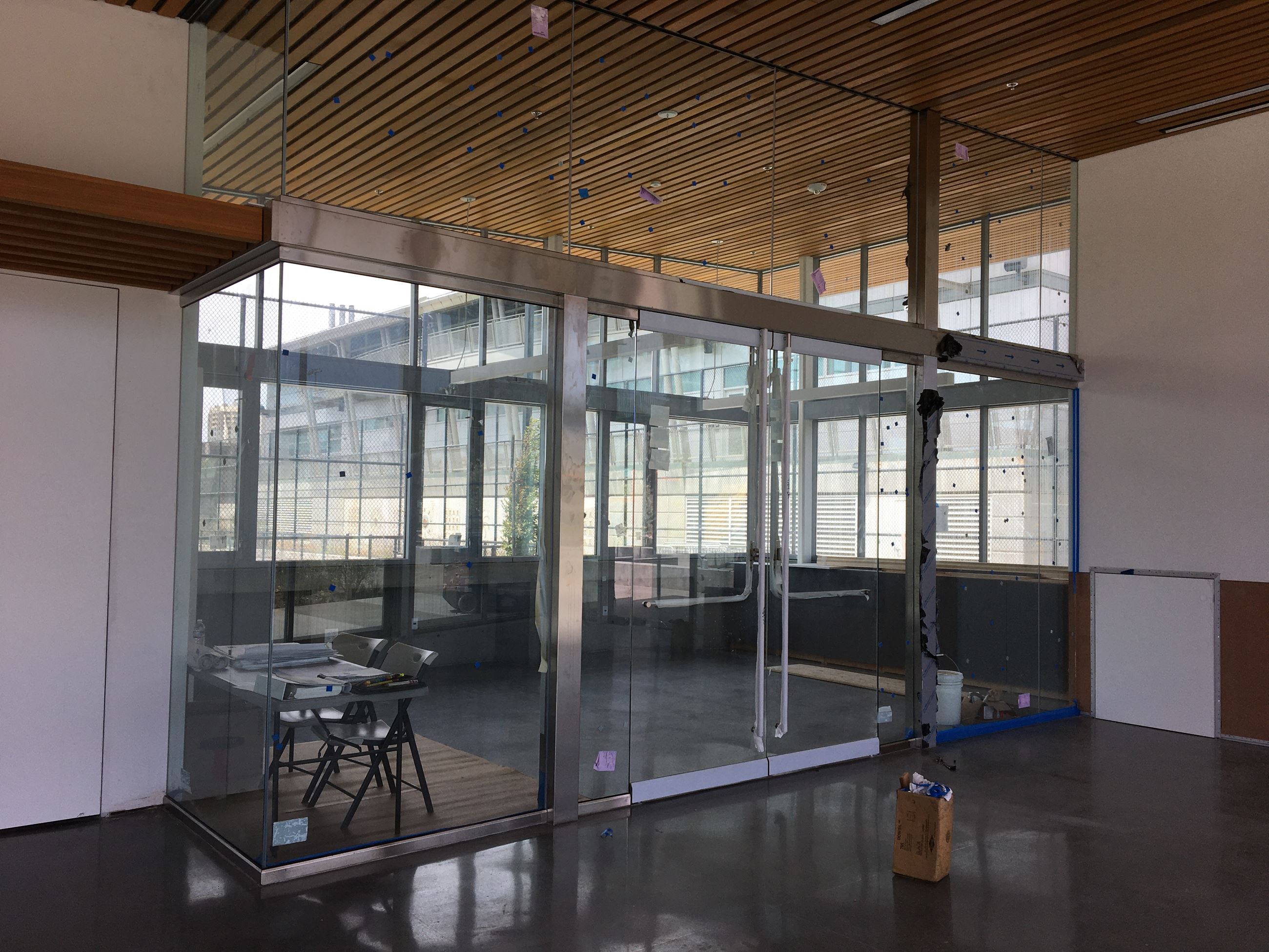 Classroom with glass walls and cement floor inside the clubhouse