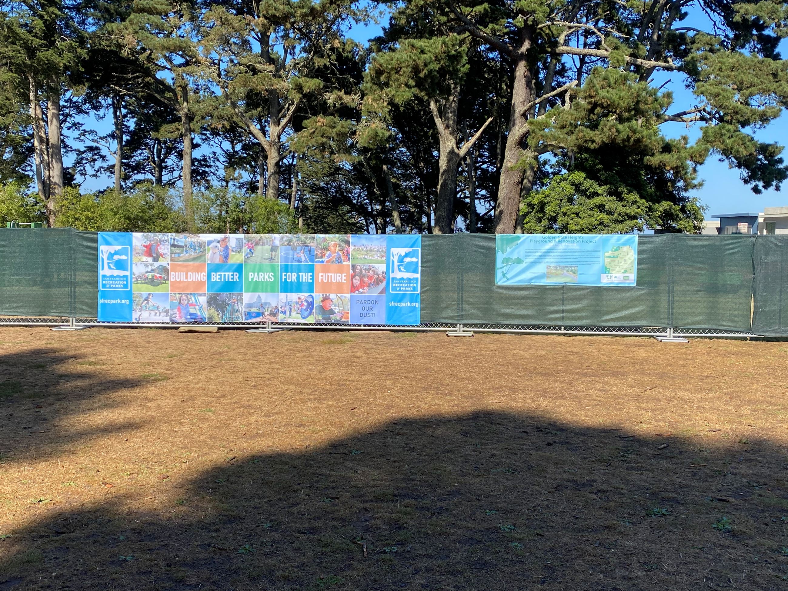 Construction banners on the green fence wrap  at Golden Gate Heights Playground