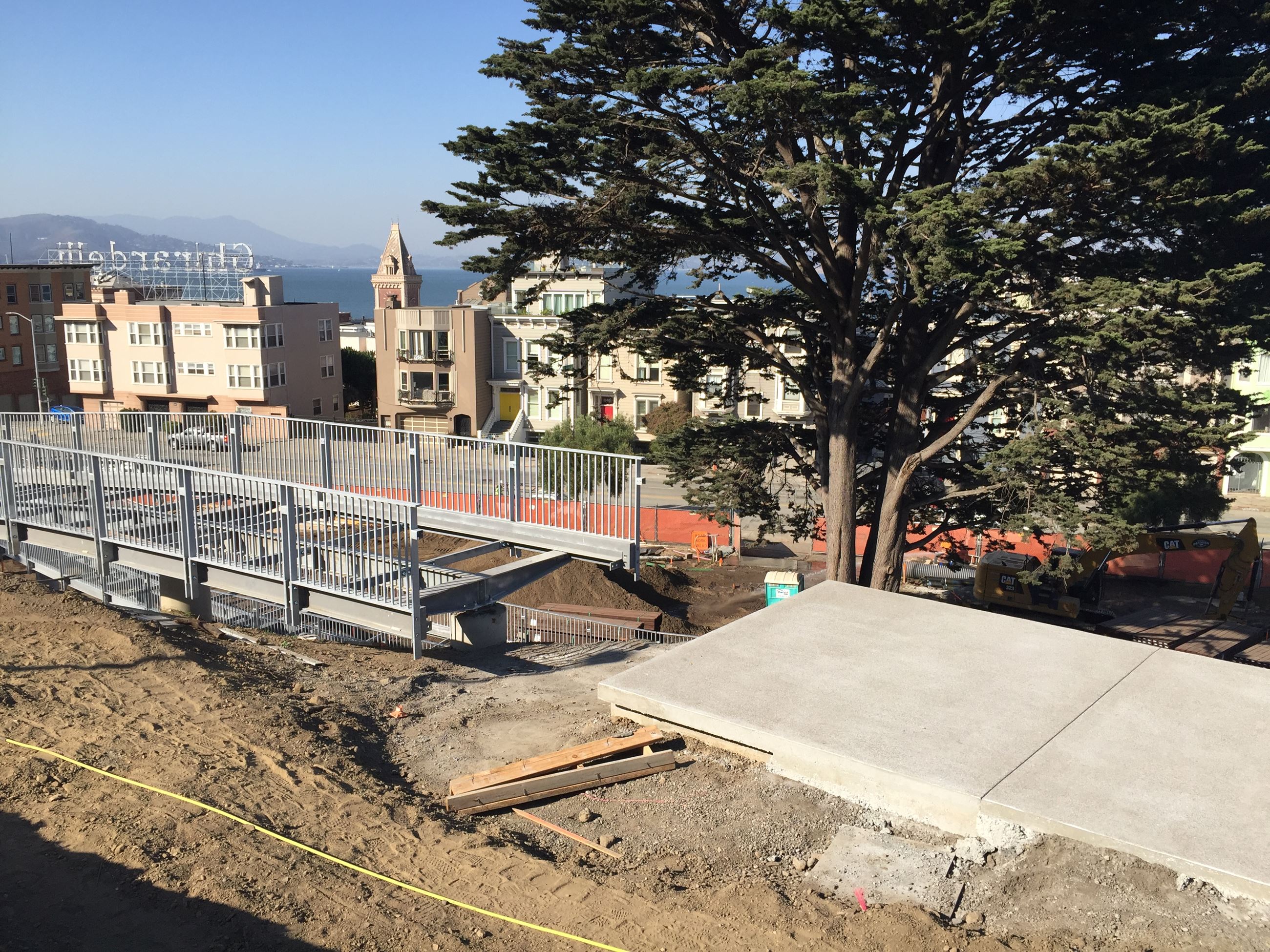 Top of the elevated walkway where it meets the concrete path to main lawn, playground, garden