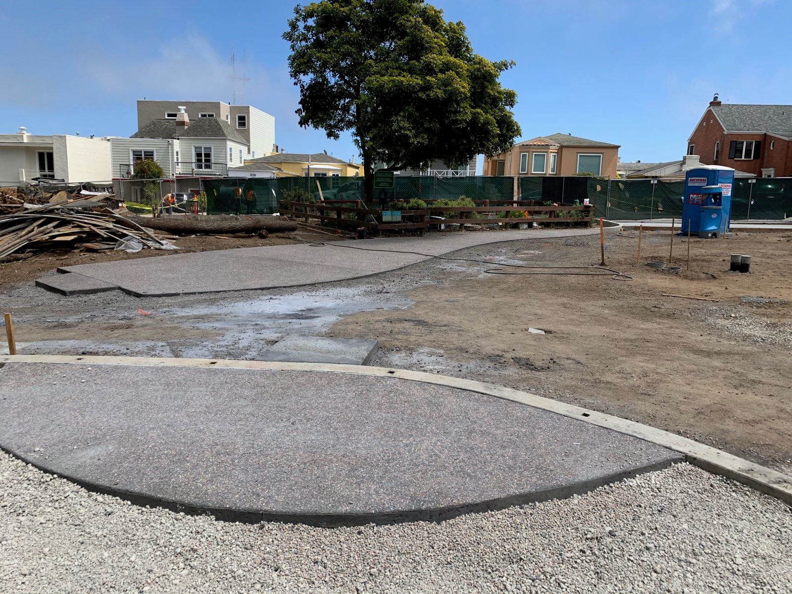 Cement has been poured for the pathway in the area next to the playground.