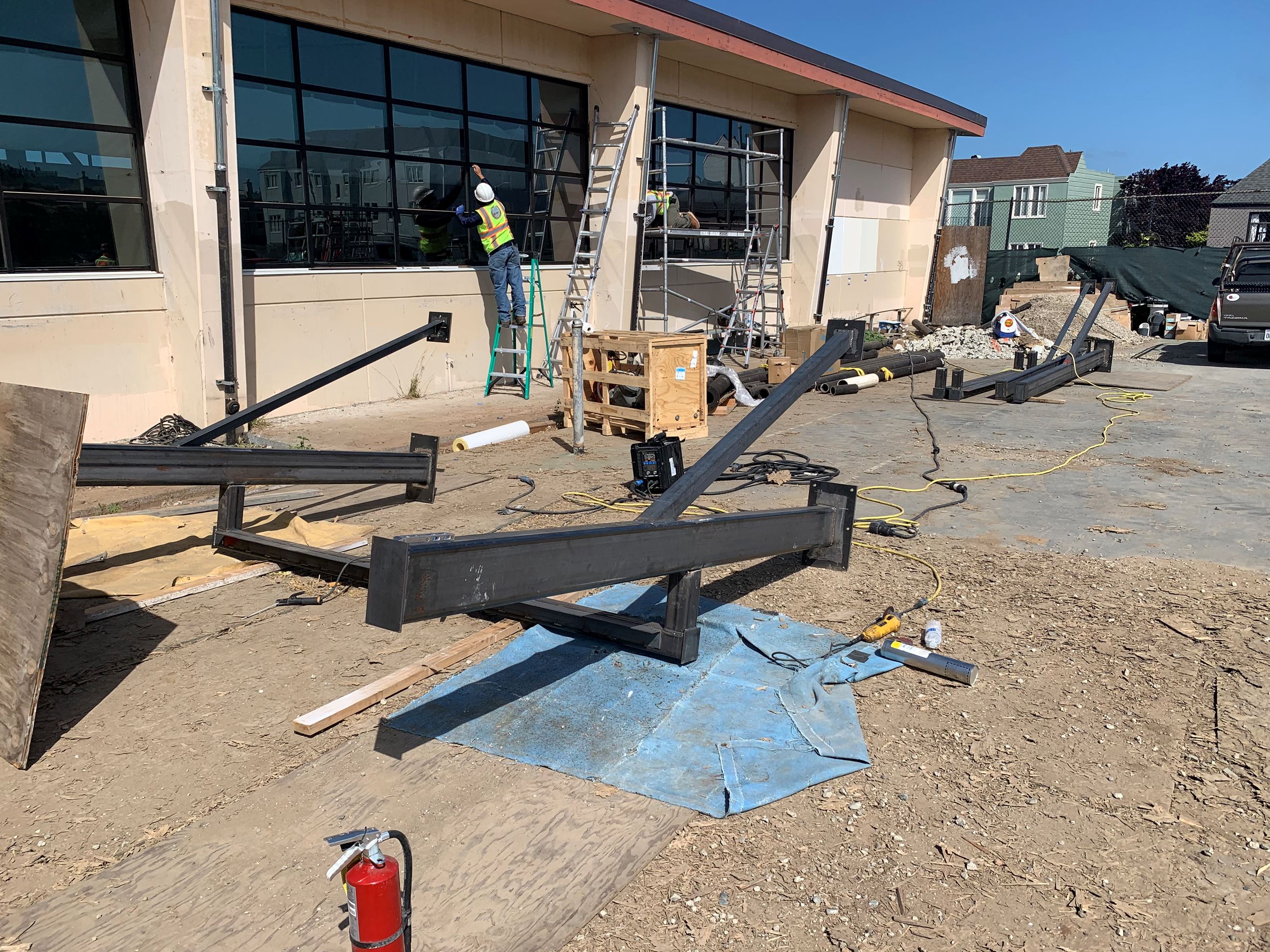 Construction worker finishing the outer windows of the pool building and construction materials