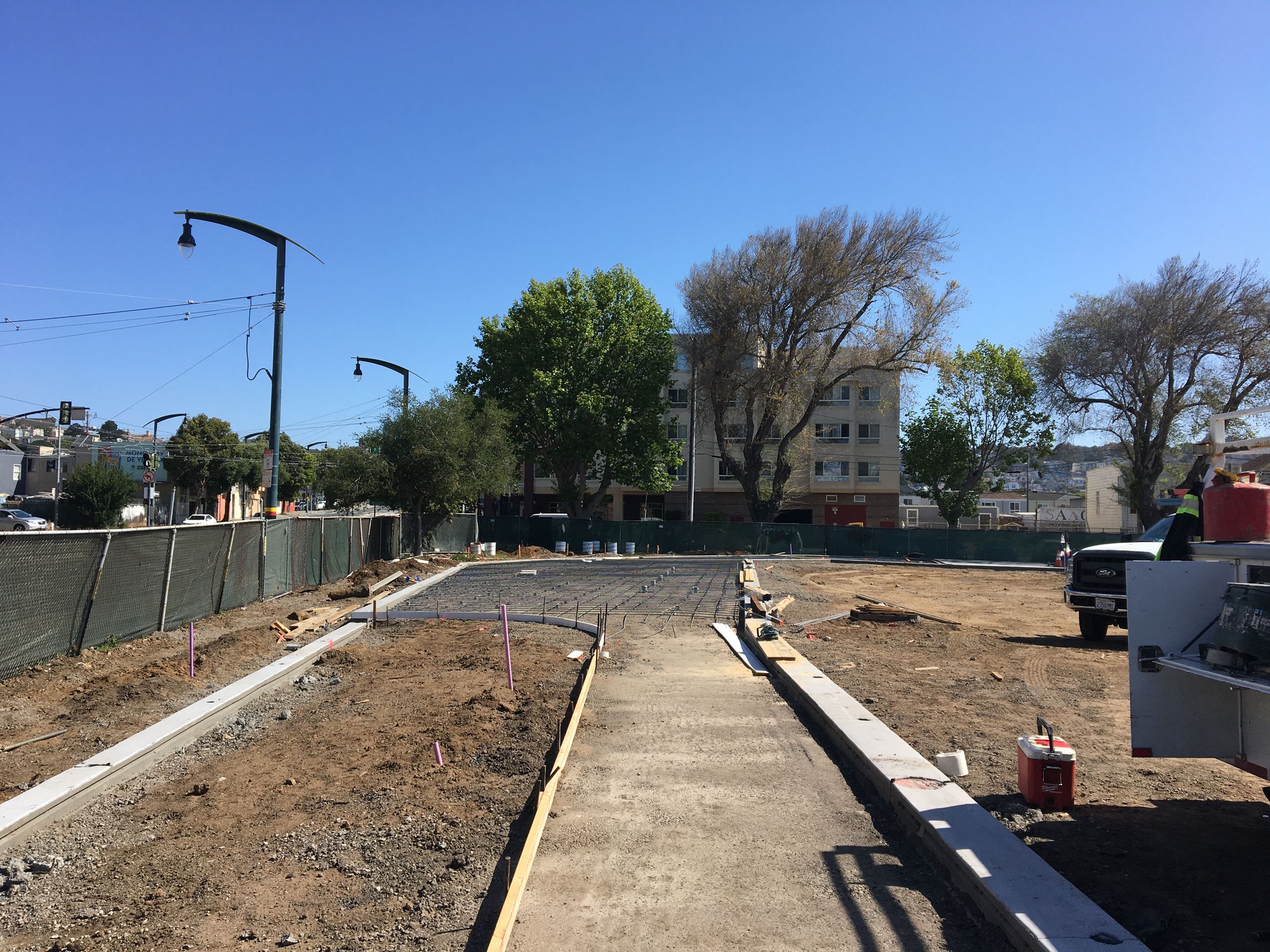 Compacted soil underlayment and cement forms for new pathway and bleacher pad.