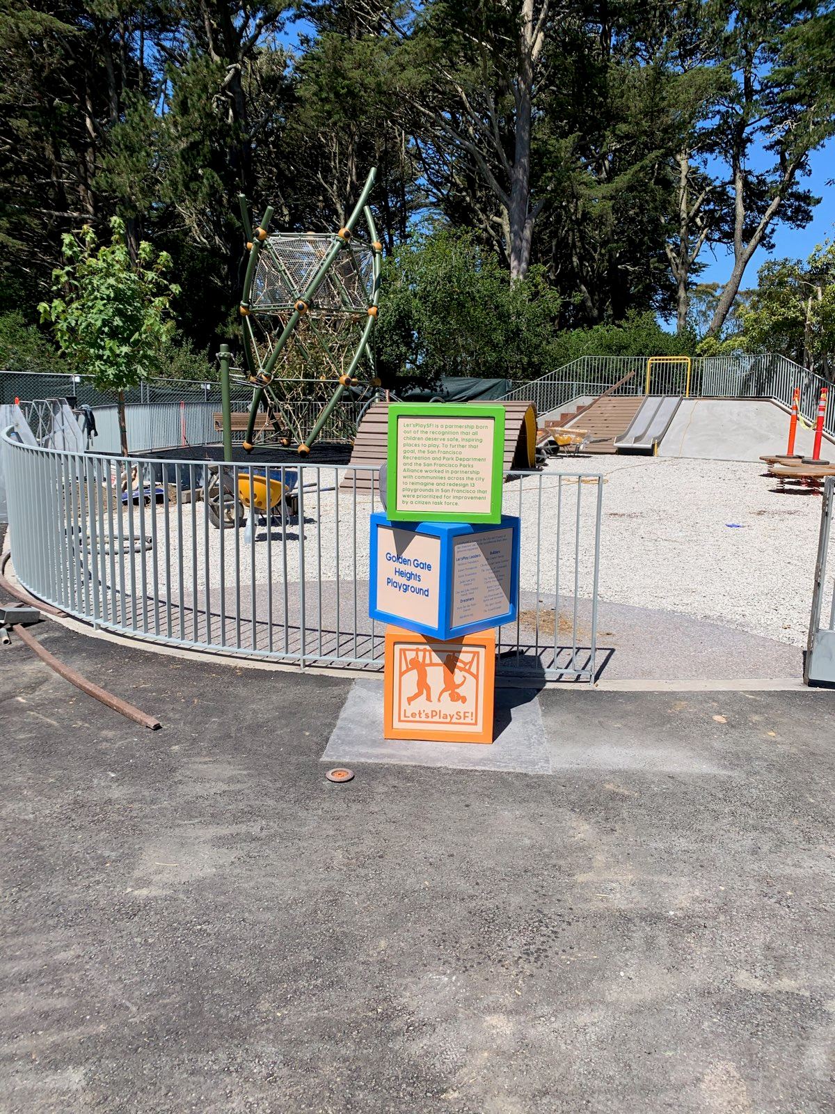 Stacked alphabet blocks with donor recognition in the foreground. Playground equipment in the back.