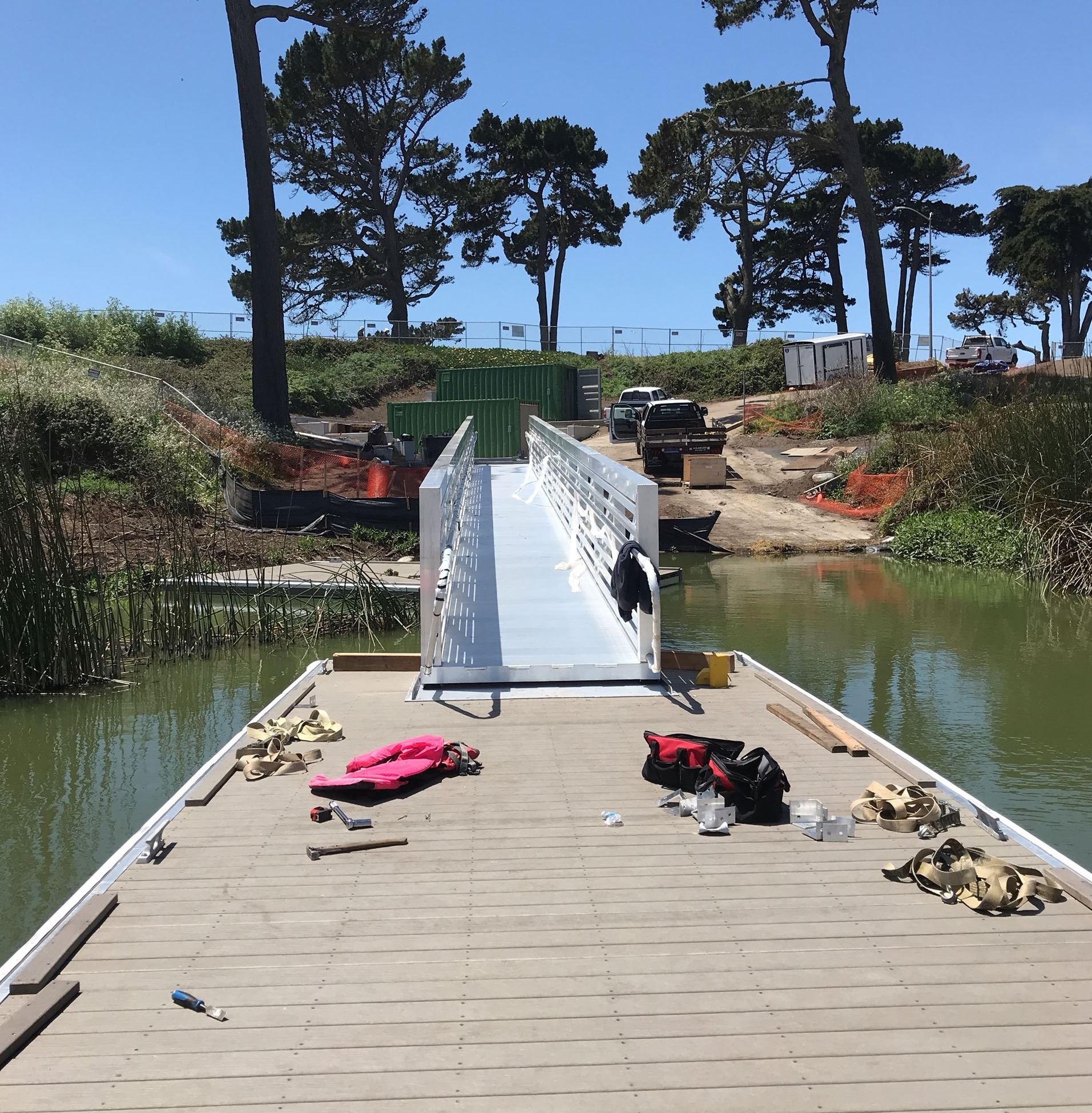View from end of the boat dock up the gangway with cement ramp in background.
