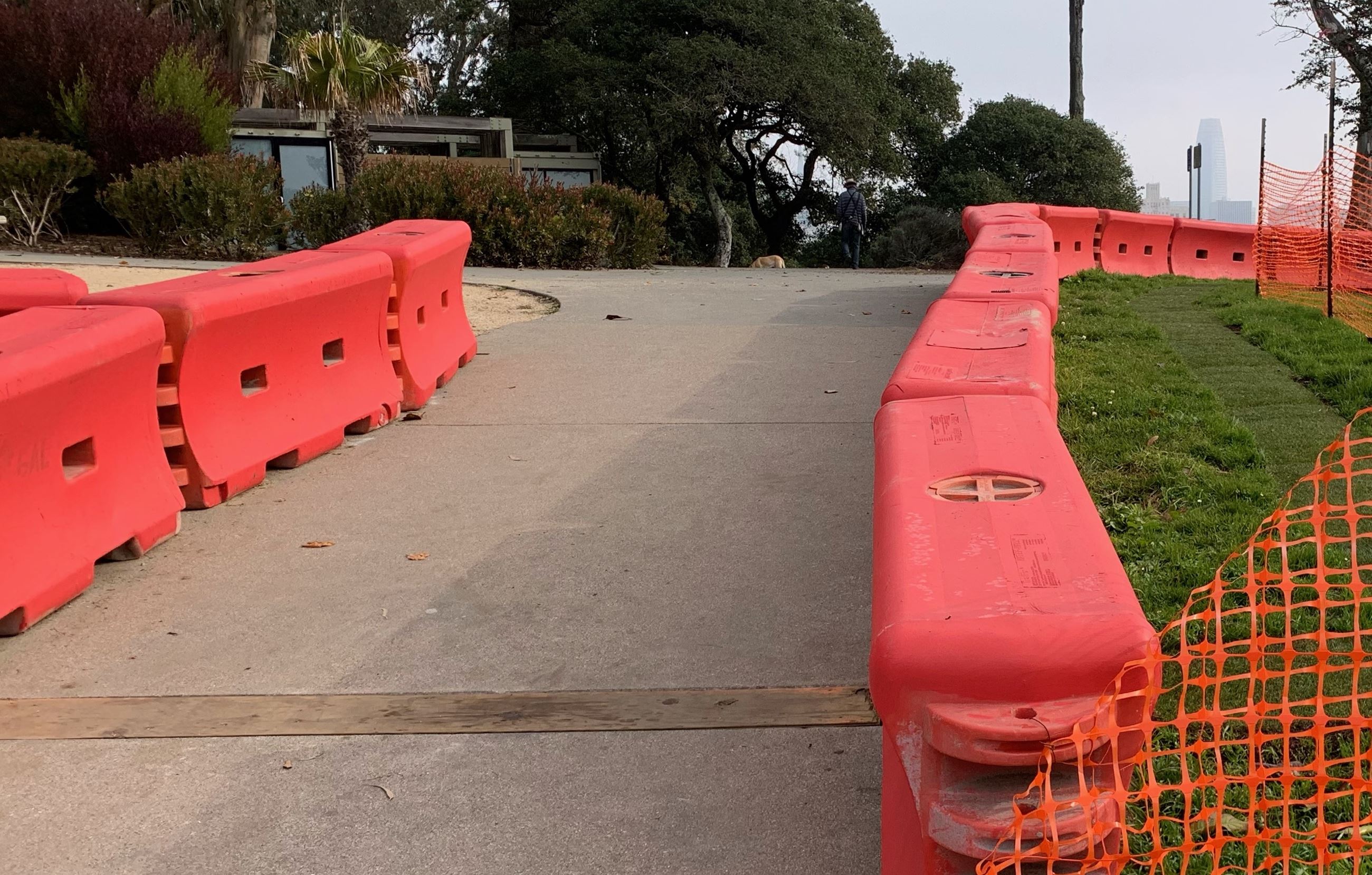 Pathway shown with orange barriers and walkway