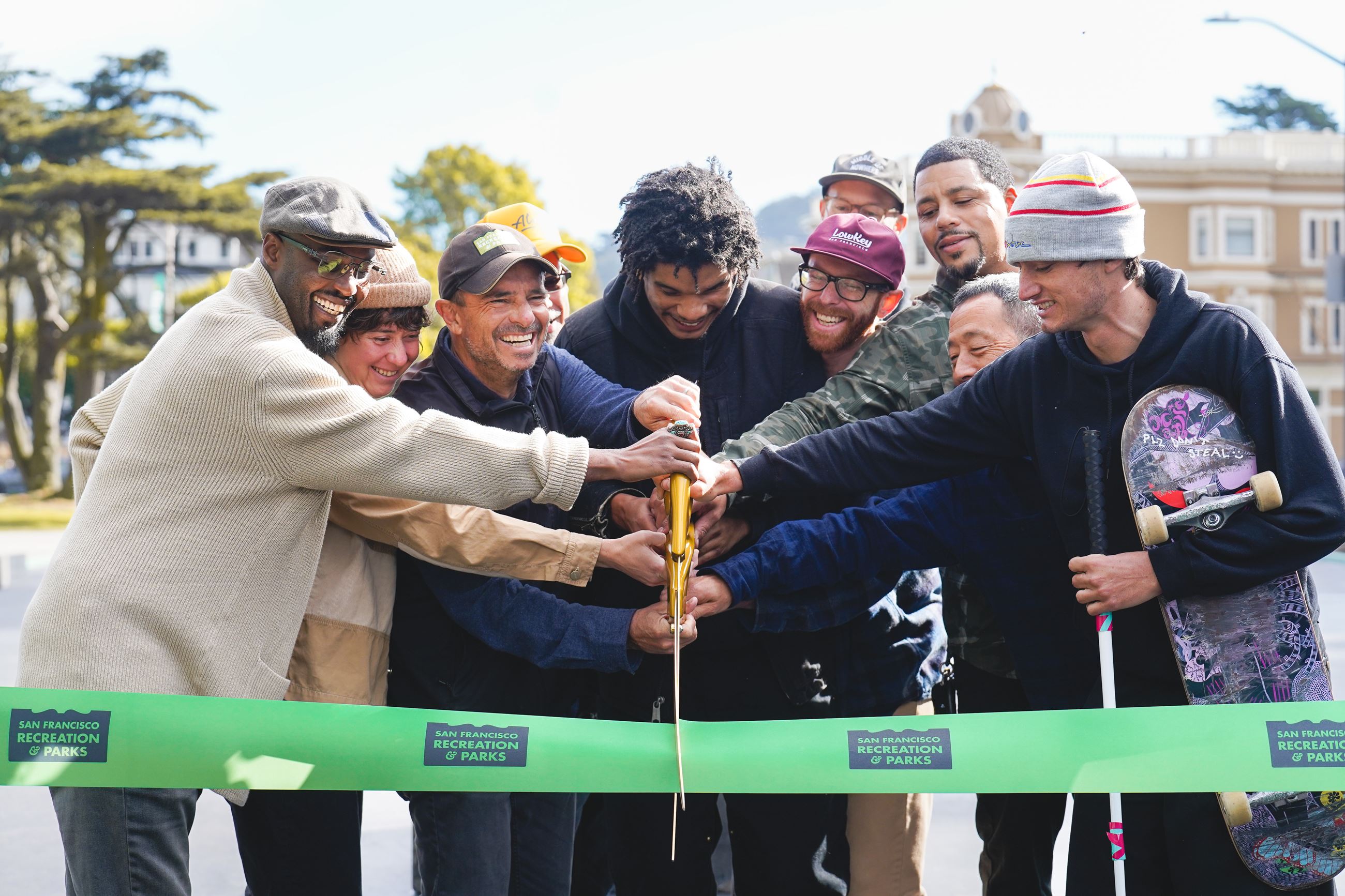 Ten people including skateboarders and Rec Park staff cut ribbon at new Waller Skate Park