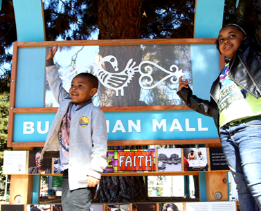 Two children standing in front of Buchanan Mall sign