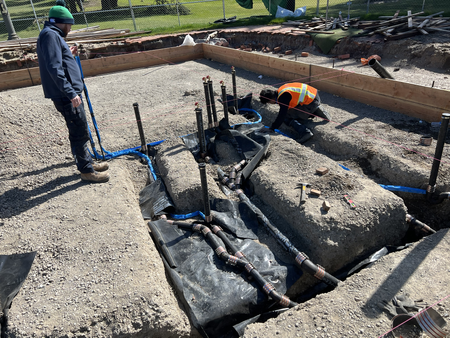 Workers installing underground plumbing at new clubhouse