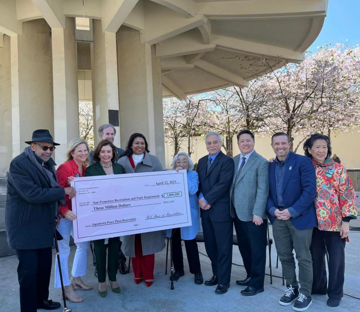 Officials gather at Japantown Peace Plaza with large ceremonial check for three million dollars