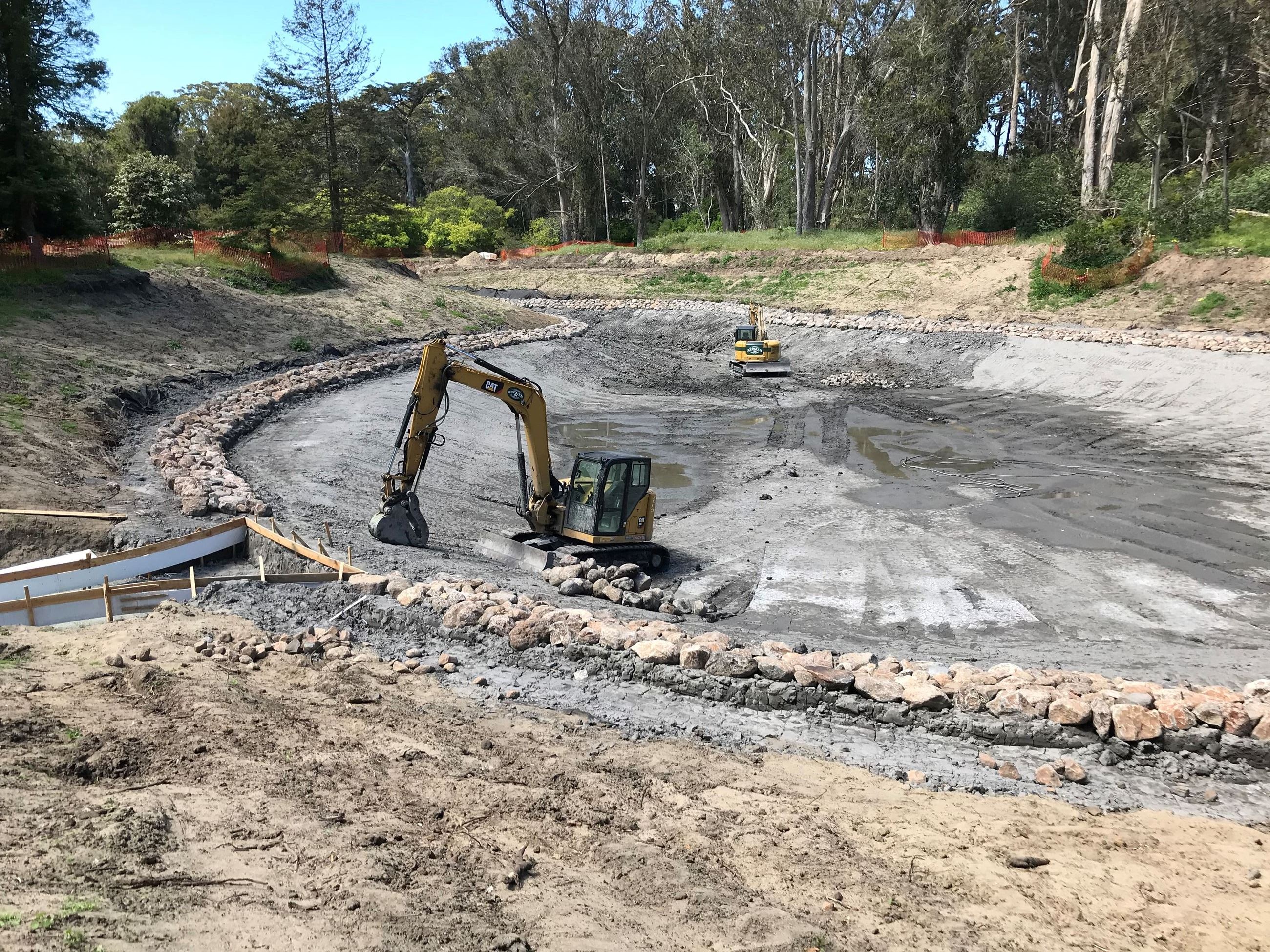 Clay liner being installed at Middle Lake in construction