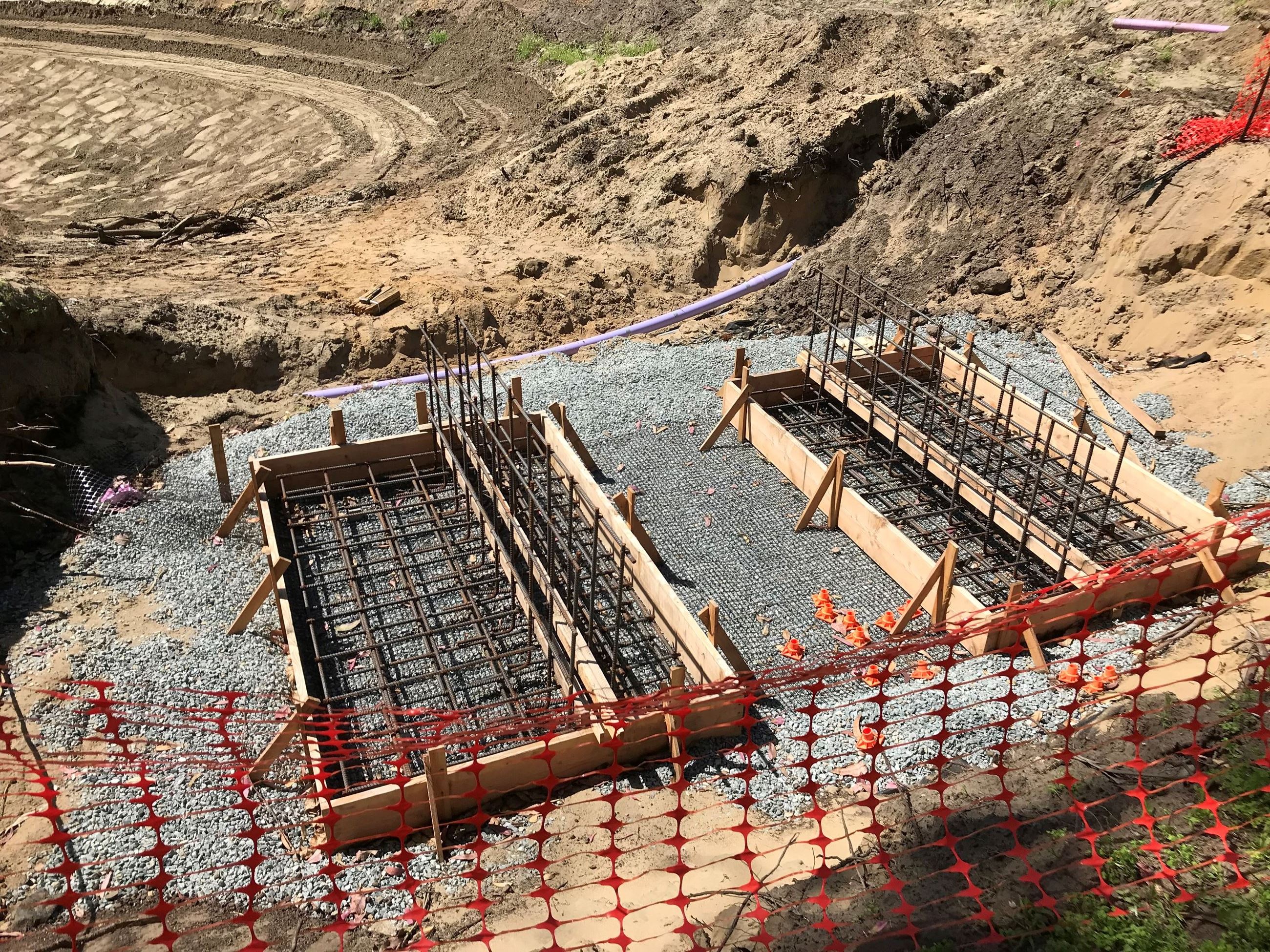 Footings for the vehicular bridge being installed at Middle Lake in construction
