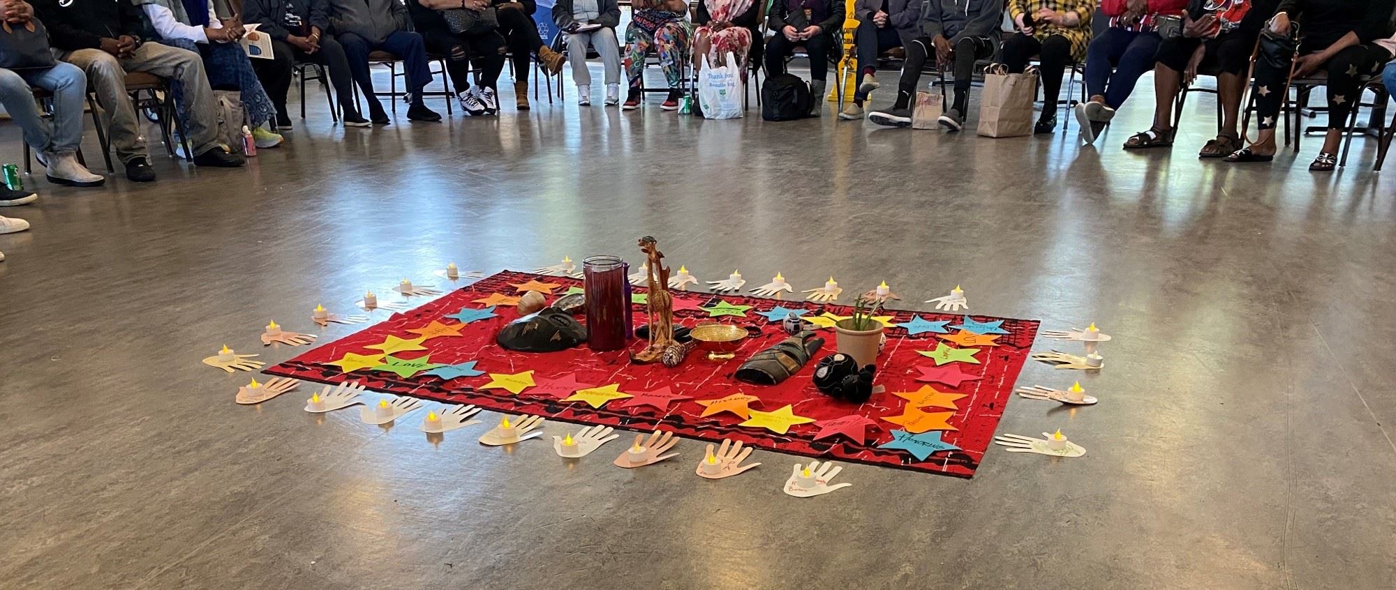 ImagePhoto from Buchanan Healing Circle depicting attendees circled around a cloth with various item
