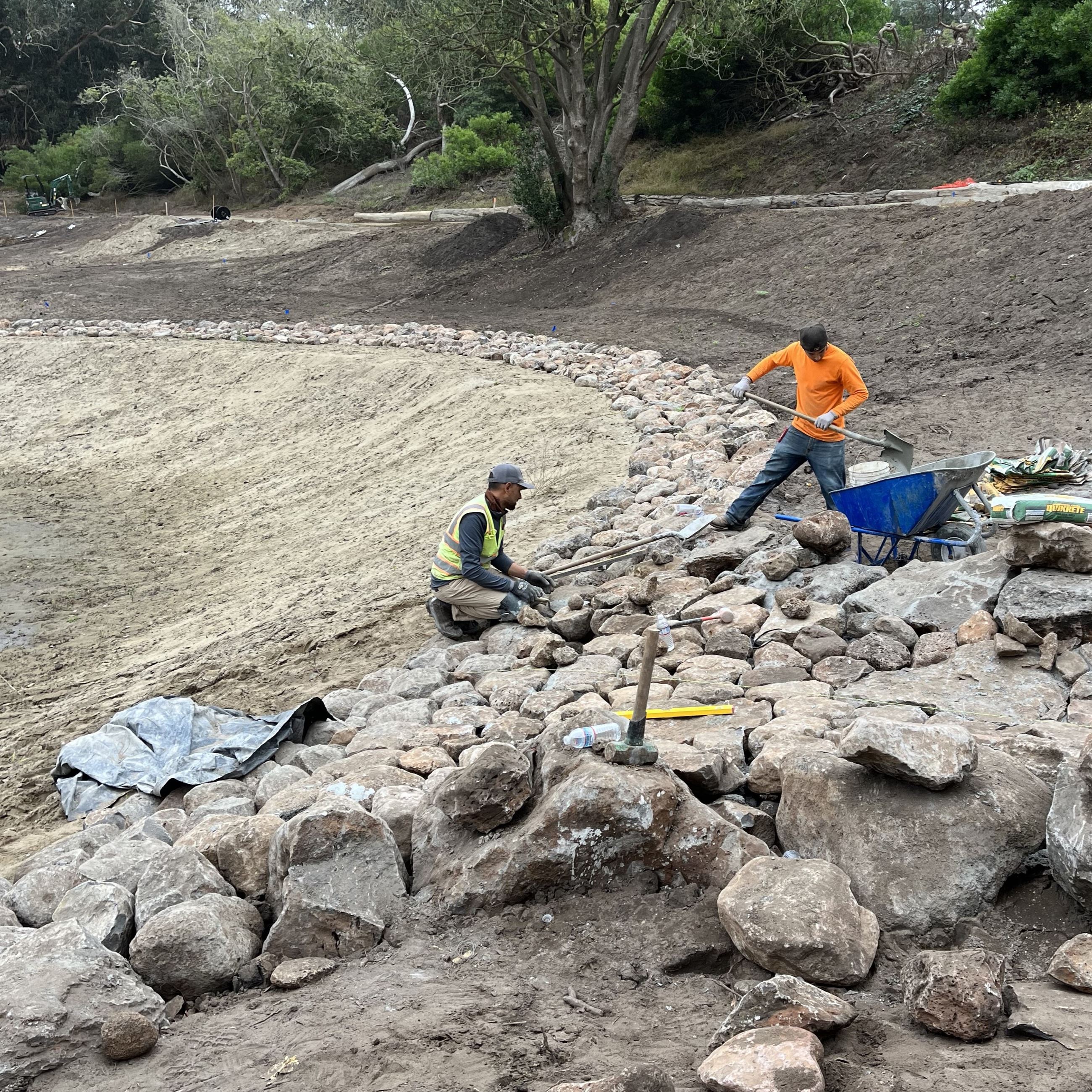 Middle Lake construction October 2023 - installing rocks along edge of lake