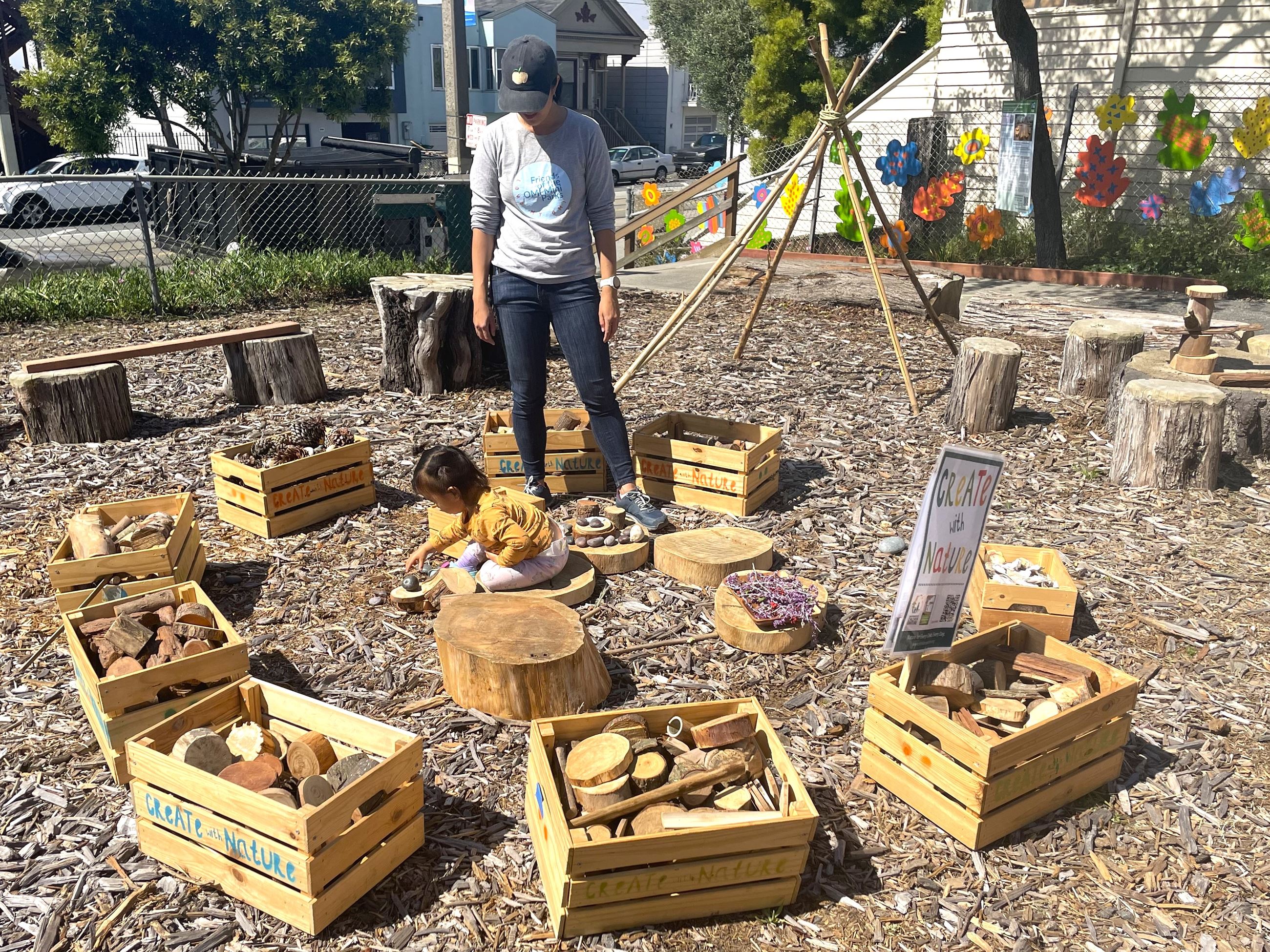 Infant plays in pop up nature exploration area