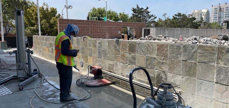 worker and equipment near planter