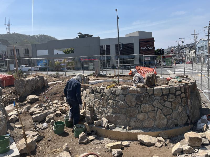 Stones being cut and formed into walls