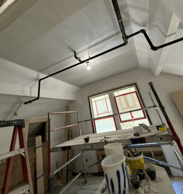 Scaffolding and taped windows inside clubhouse