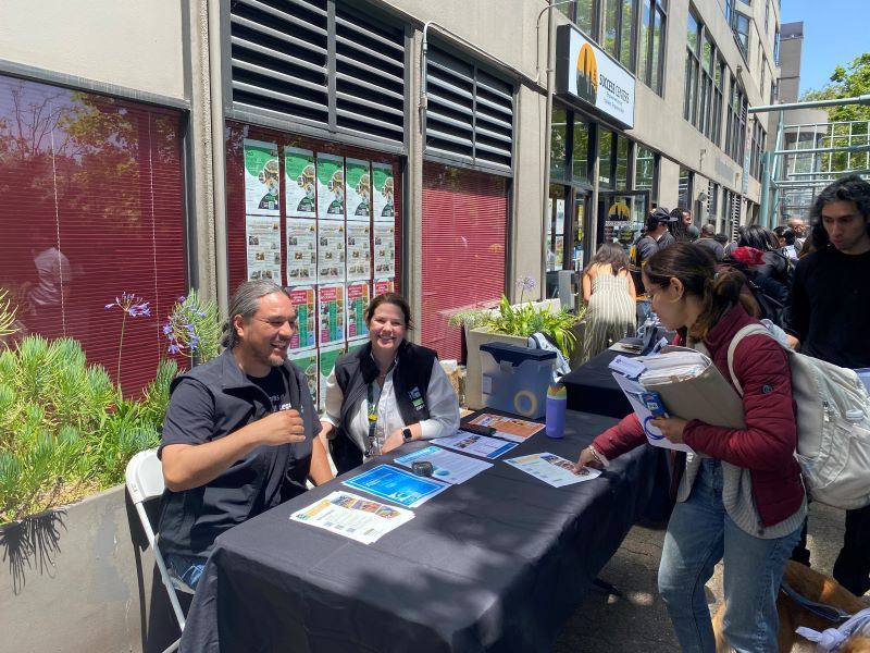 Two people sitting at a table at job fair