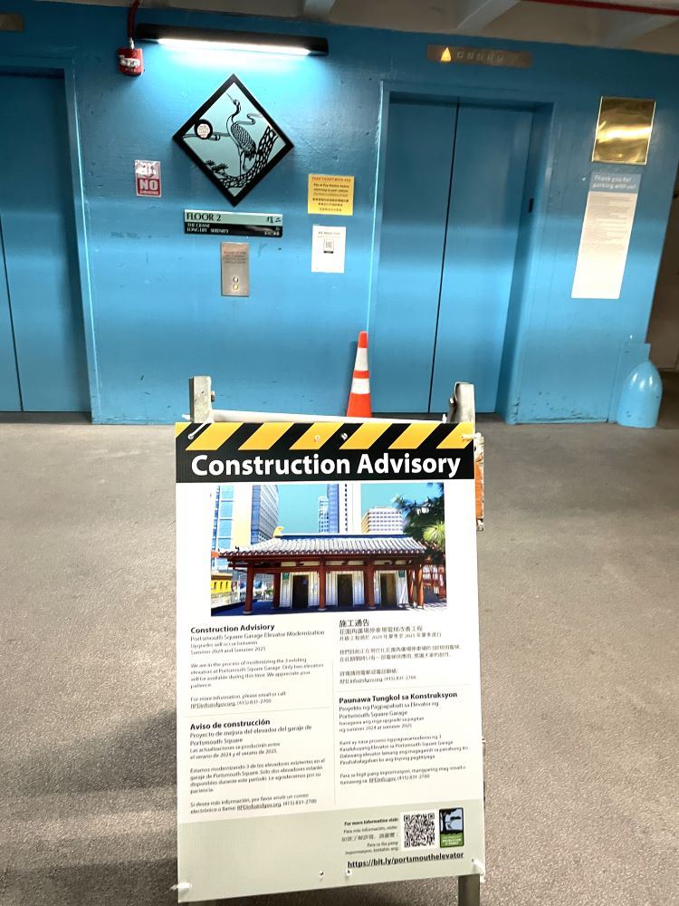 Construction sign in front of blue elevator doors, construction August 2024