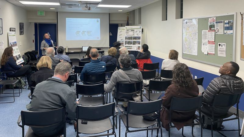 People seated watching a presentation