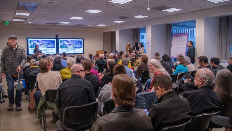 Large gathering of participants at a community meeting