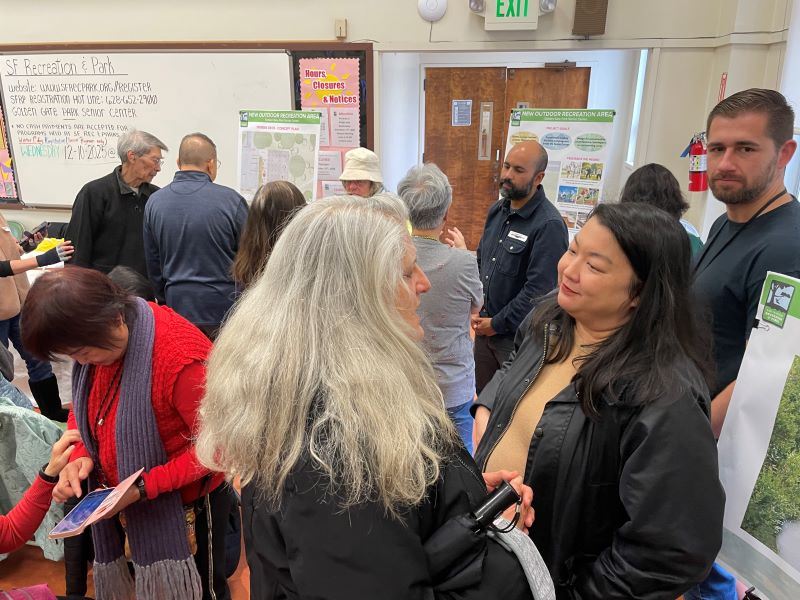 Meeting participants talking with staff