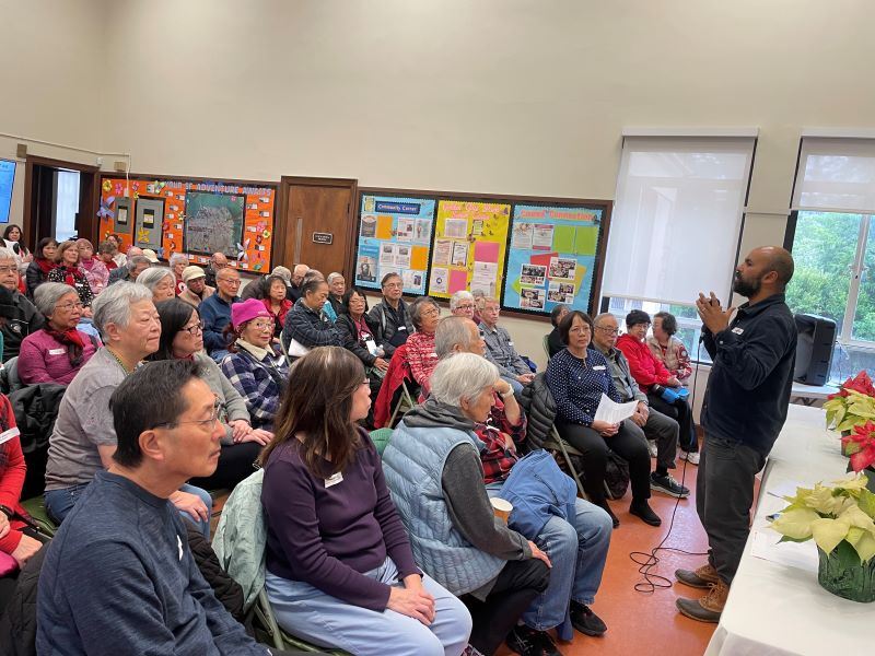 Speaker presenting to large group of seated participants