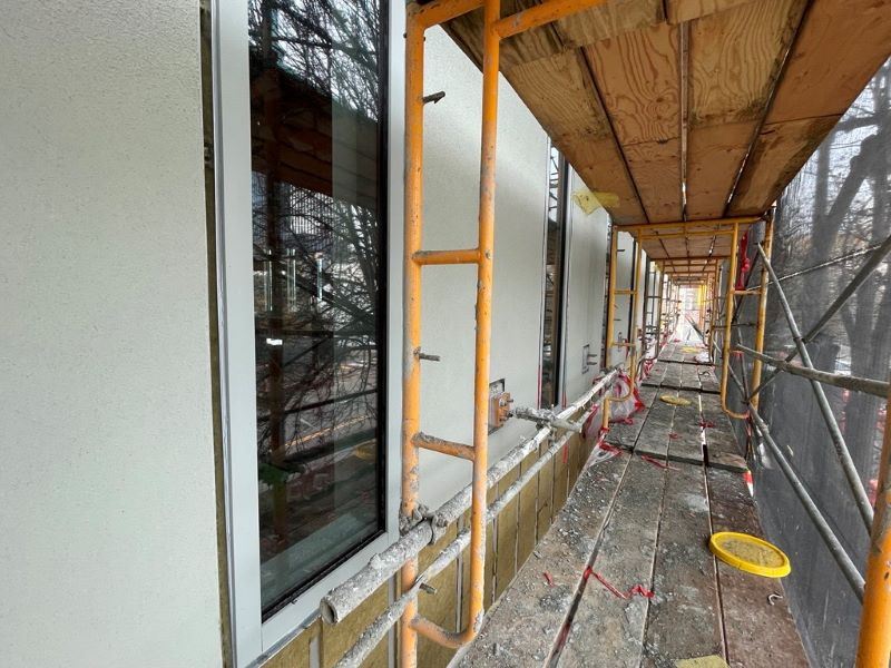 Gene Friend construction December 2025 -Recently Applied Plaster_Building Exterior_6th Street Facade